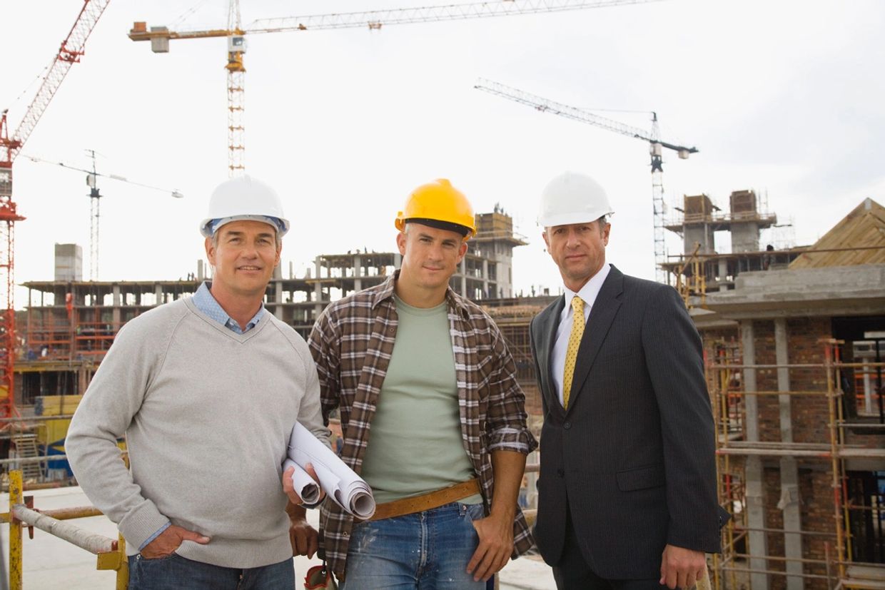 Cliff Davis of St Petersburg Florida standing with construction  workers  on a building site