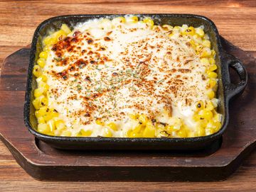 Corn with cheese baked on top.