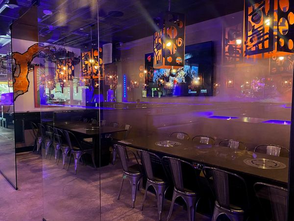 Luxurious VIP room separated from main dining area with two tables containing four grills in total.