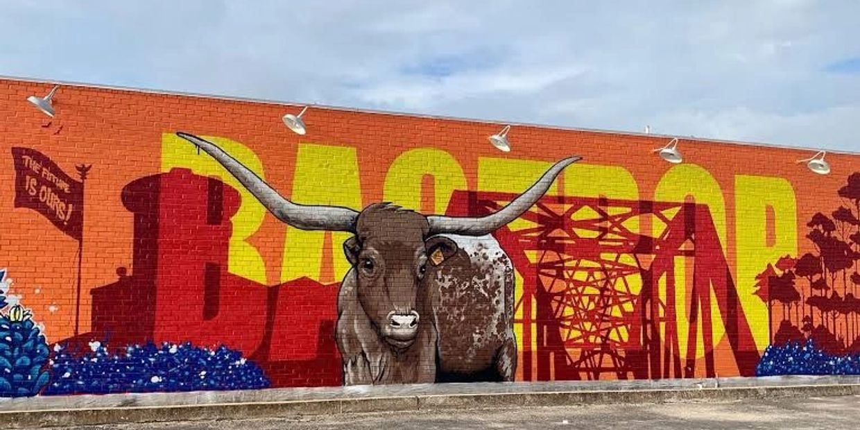 Street art mural with a longhorn and text "Bastrop."