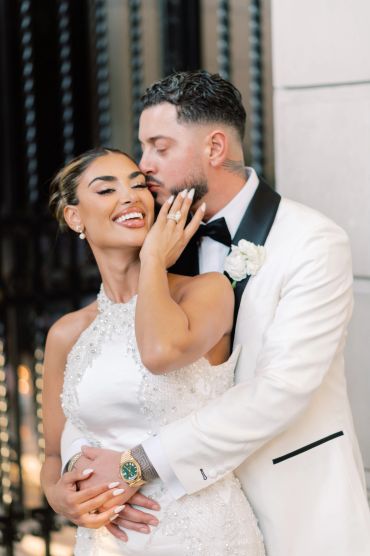 Couple in wedding attire sharing a tender moment.