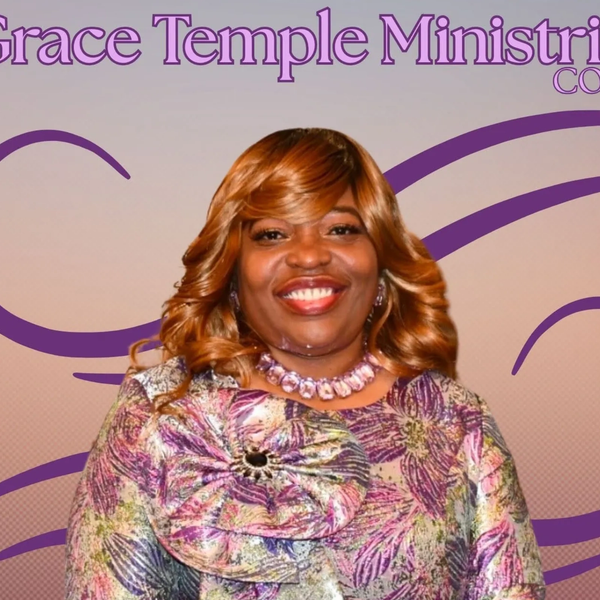 Smiling woman in a floral outfit at Grace Temple Ministries event.