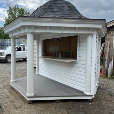 White outdoor kiosk with columns and a serving window.