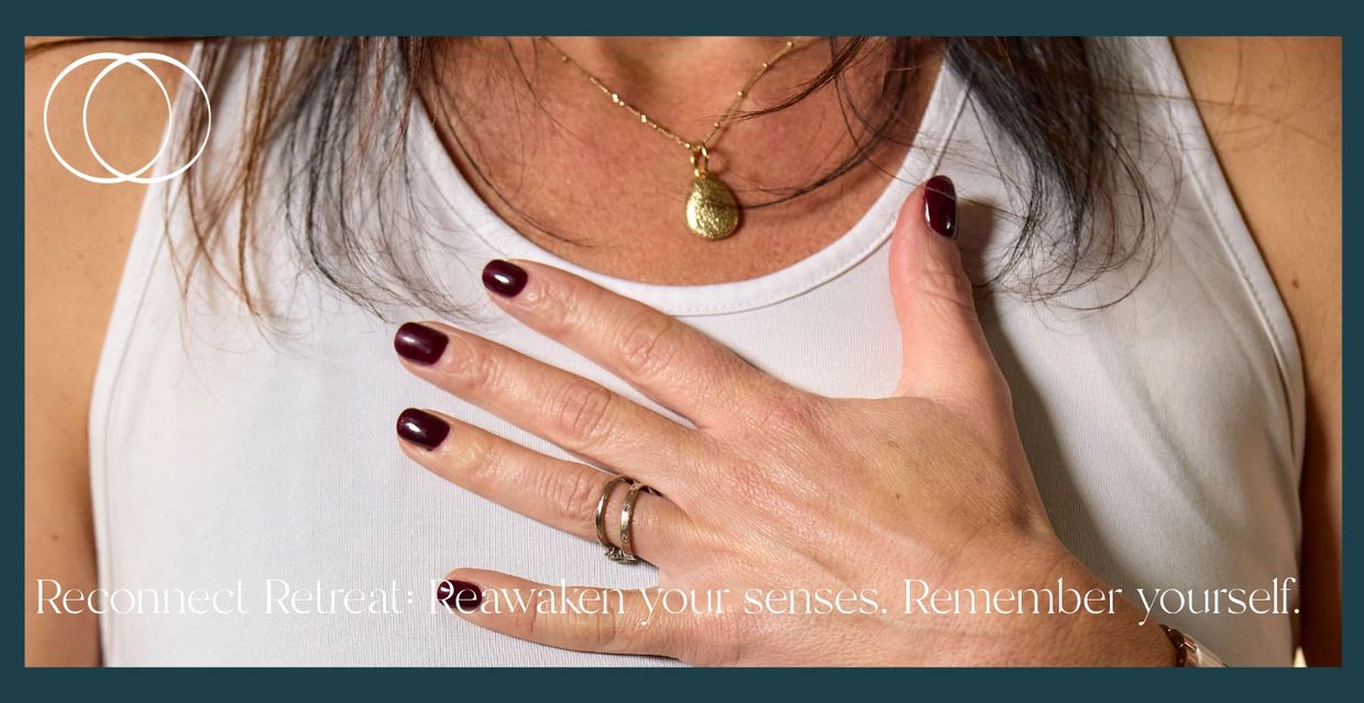 Woman touching her chest with words about reconnect retreat.