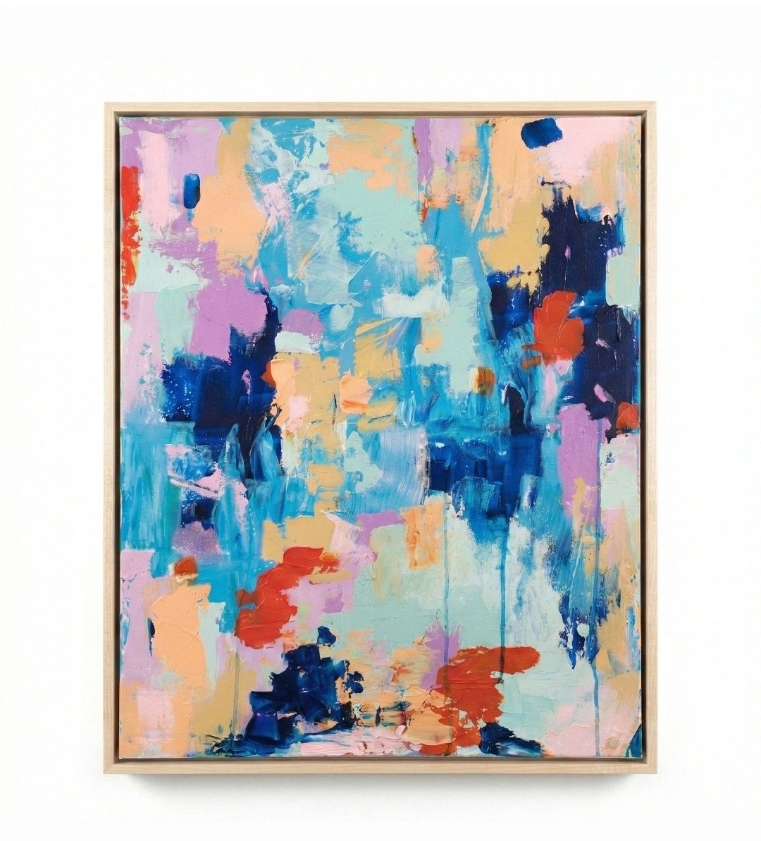Abstract painting with vibrant blues, reds, and pastel hues in a wooden frame.