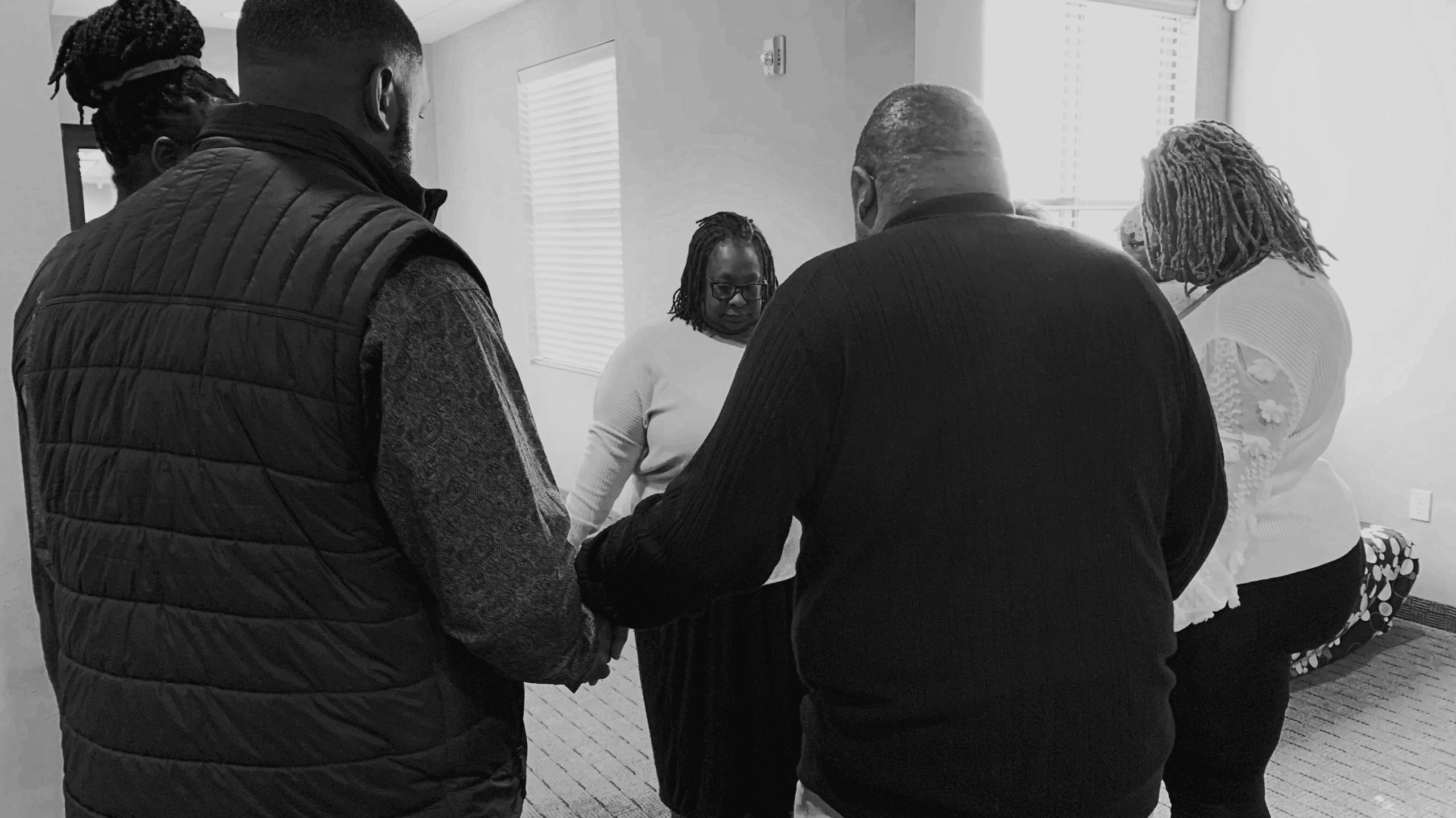 people in a circle praying