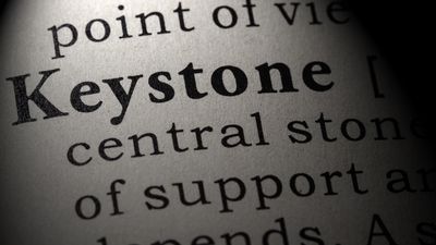 The word keystone is shown with other words defoning ot such as central stone, support