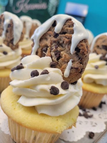 A vanilla cup cake topped with cookie