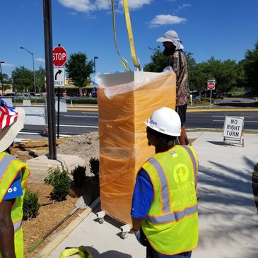 Custom light tower bases being craned into place