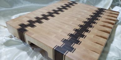 Wooden cutting board with unique interlocking design.