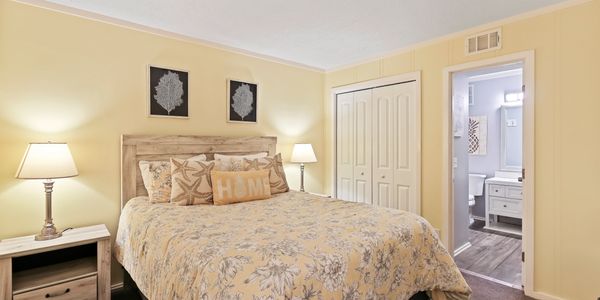 Carpeted Main bedroom with king-sized bed and crown molding