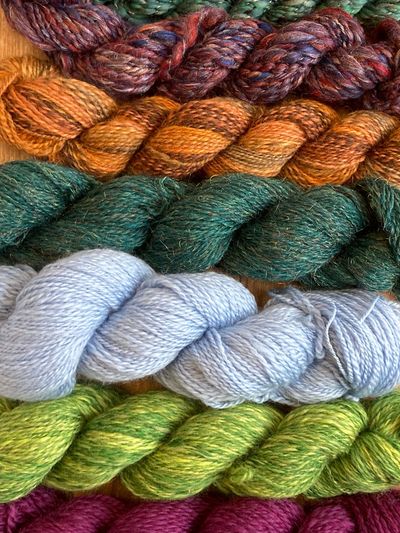 Rows of colorful yarn skeins in various shades.