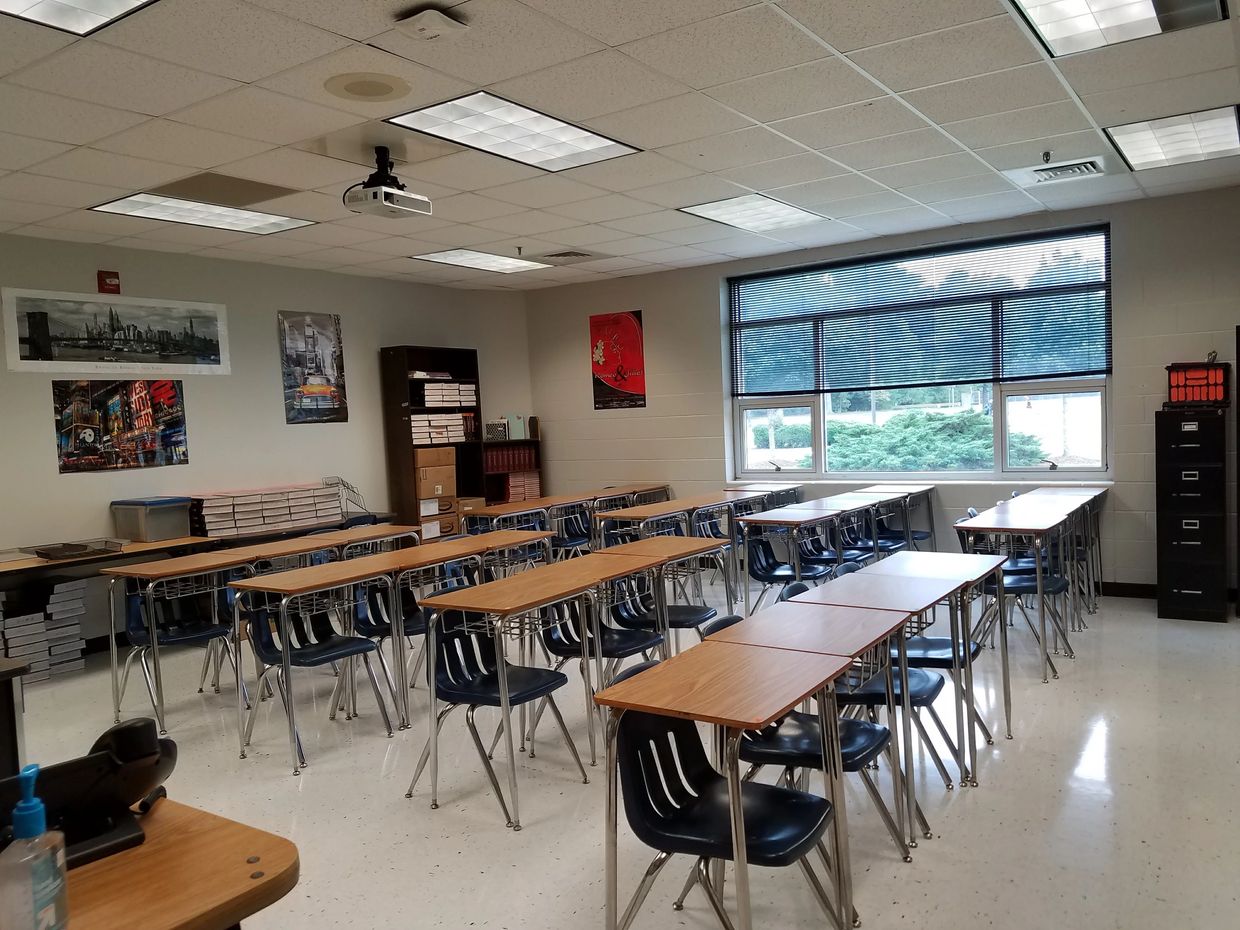 Empty classroom with desks and chairs.