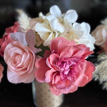 Elegant floral arrangement with soft pink roses, blush peonies, and white hydrangeas in a vase.