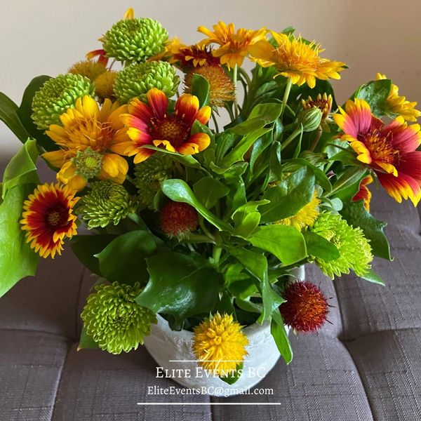 Flower bouquet in yellow and orange. Centrepiece created by Elite Events BC.