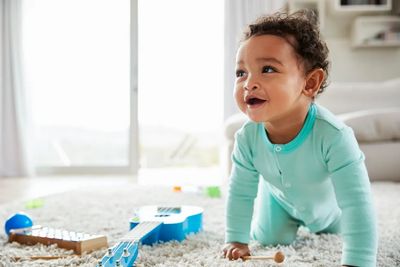 baby crawling looking smiling