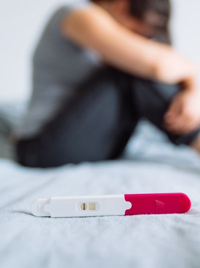 Woman crying with negative pregnancy test