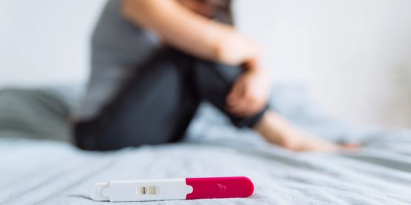 Woman crying with negative pregnancy test