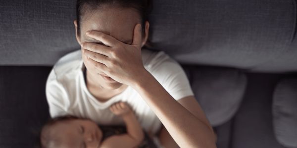 mum feeling anxious sad worried with baby