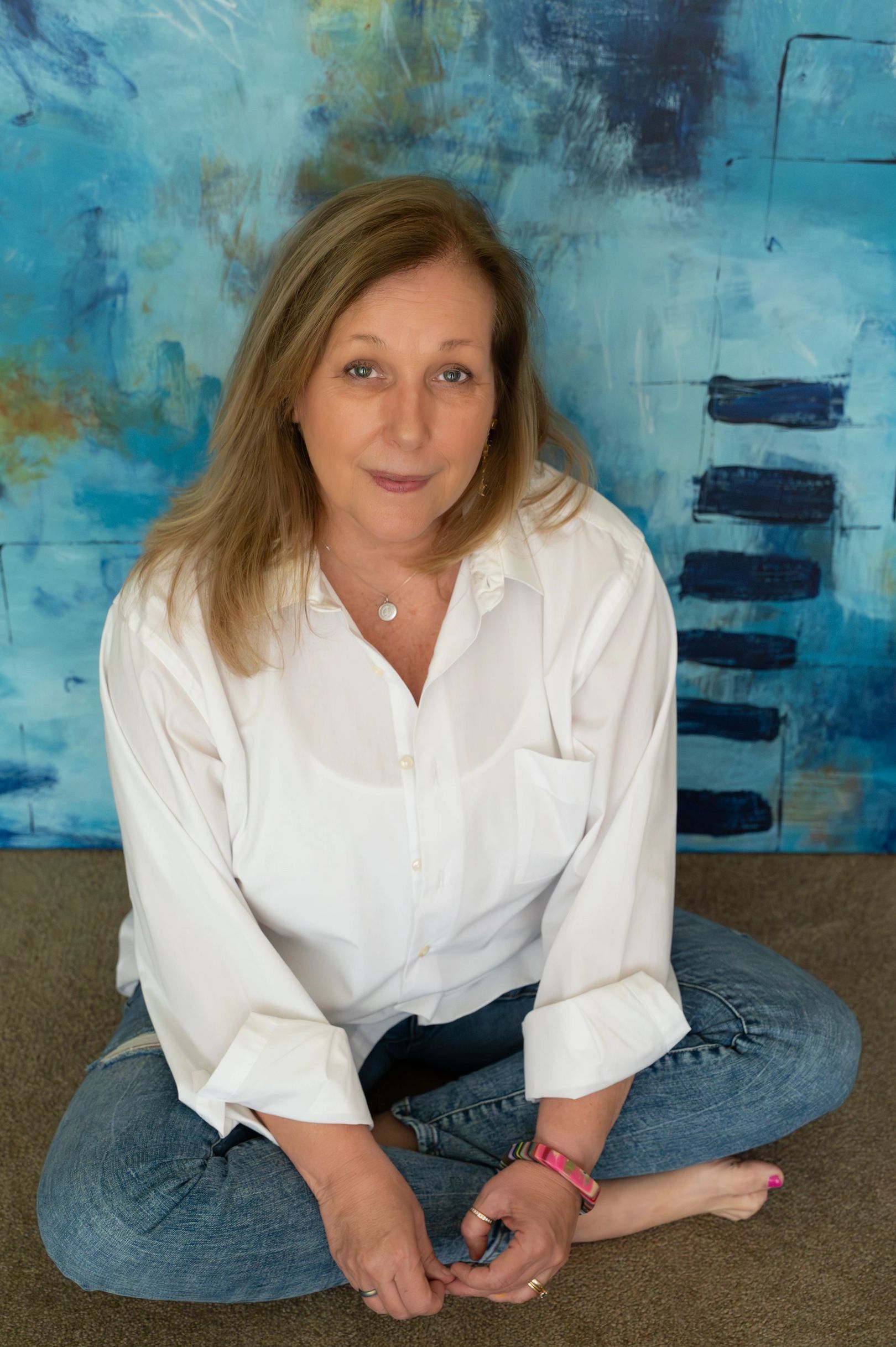 Kerrie Neumann sitting in front of art
