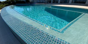New infinity pool in St. Petersburg, FL with turquoise glass tile by Living Pools