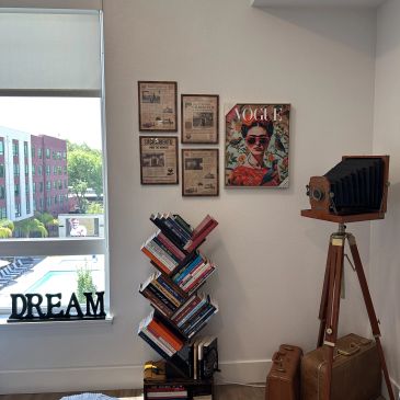 Cozy corner with books, vintage camera, and inspirational decor.
