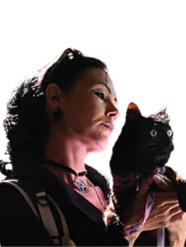 Woman holding a black cat and looking thoughtfully ahead.