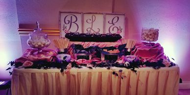 Decorated dessert table with 'BLE' initials and treats.