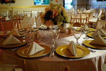 Elegant dining table setup with folded napkins and floral centerpiece.