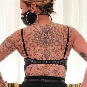 Woman's back with custom tattoos