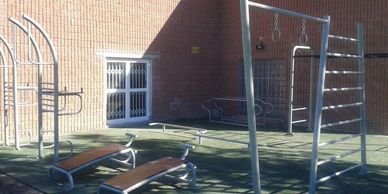 a small scale outdoor gym setup in a correctional facility/ prison
