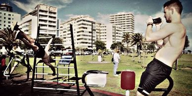 a stylish image of a professional calisthenics athlete using outdoor gym equipment in sea point 