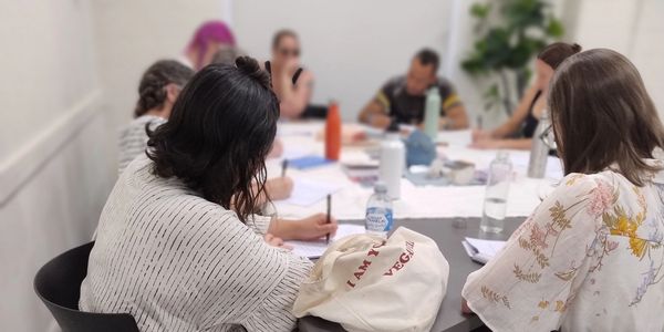 Reiki Share in Adelaide with participants completing workbook activities.