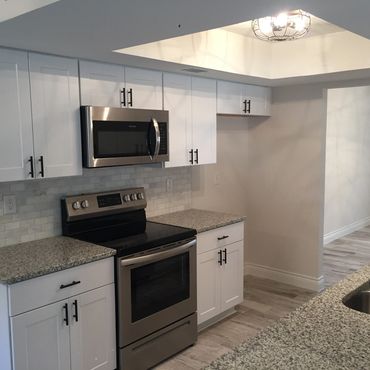 After Modern Kitchen Upgrades - New lighting, new cabinets, new counters, new backsplash, new tile