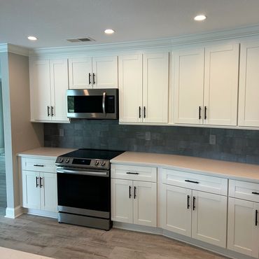 After Full Kitchen Redesign, Demolition, and Remodel - New Cabinets, New Tile, New Countertops. 