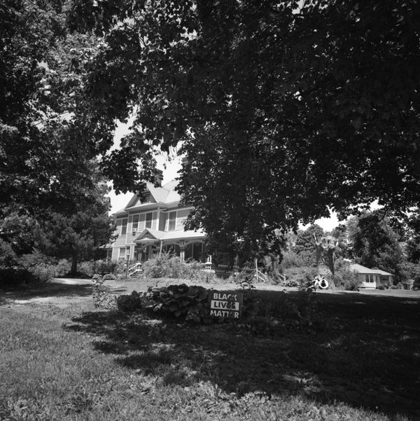 A Black Lives Matter sign seems out of place. A police car following me after I took this picture.