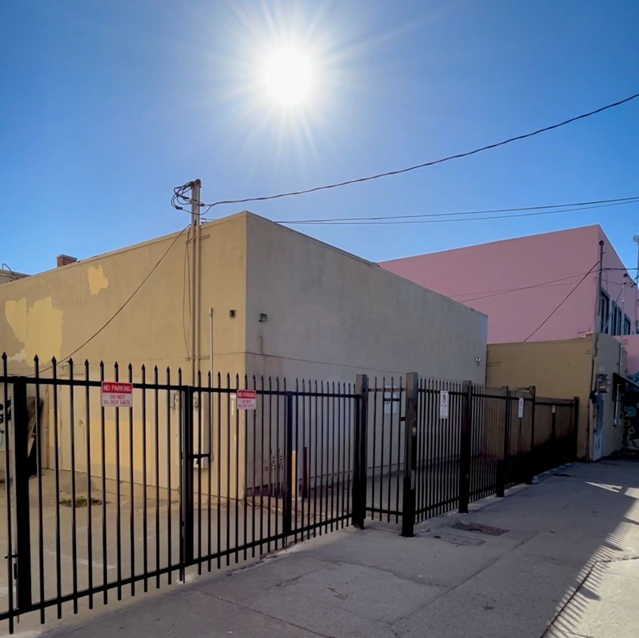 A metal commercial security fence and gate, powder coated in black.