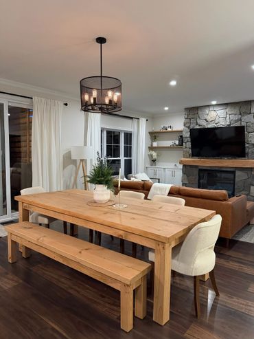 Cozy dining area with wooden table and bench in a modern living room.