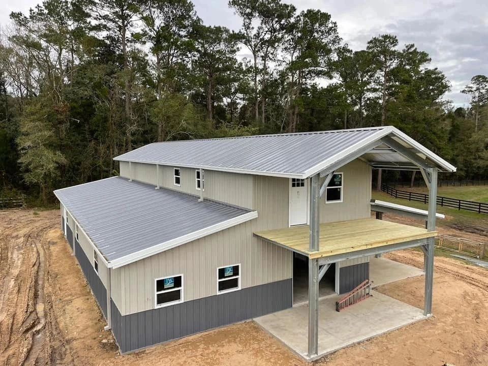 Newly constructed two-story metal building in a rural area.
