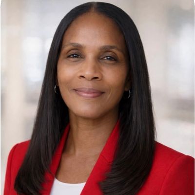 Professional woman with long straight hair wearing a red blazer.
