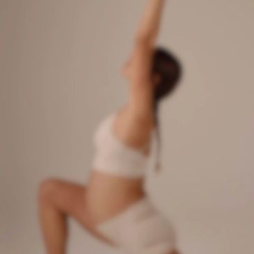 Blurred image of a person stretching or doing yoga indoors.