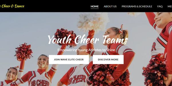 Youth cheerleaders in red uniforms performing with pom-poms outdoors.