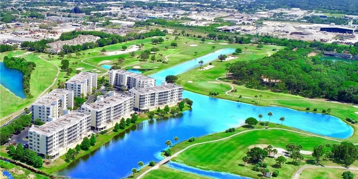 A residential complex by a golf course with lakes.