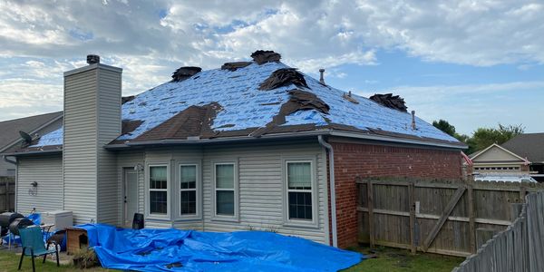 A house under construction with plastic sheets