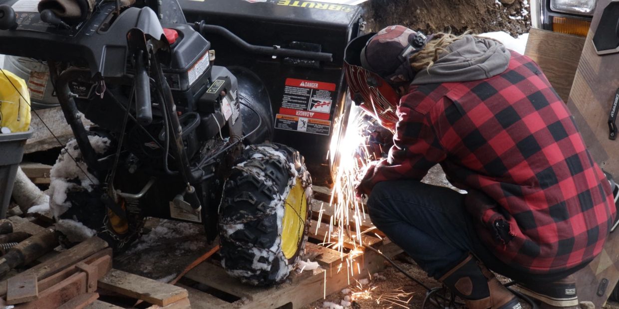 REPAIRING A SNOW BLOWER BY WELDING A NEW SUPPORT BRACKET FOR THE WHEELS