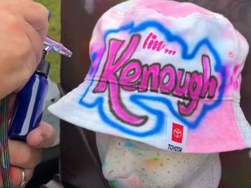 airbrush artist spraying a hat 