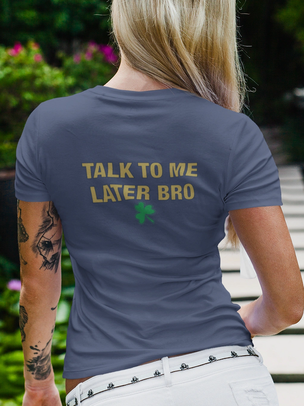 Woman with tattoo wearing a shirt that says, "Talk to me later bro."