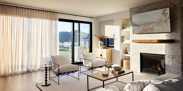 Bright modern living room with fireplace and view.