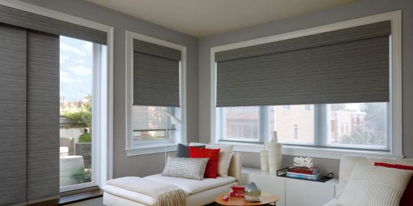 Modern living room with large windows and gray blinds.