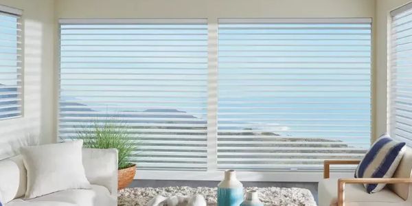 Cozy living room with ocean view and modern blinds.